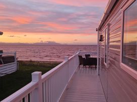An outdoor area with a deck and furniture at Craig Tara Holiday Park - Holiday Accommodation 12278 Ayr