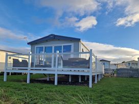 A holiday home with a deck and outdoor furniture at Craig Tara Holiday Park - Holiday Accommodation 12278 Ayr