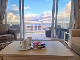 A living room with a view of the sea at Craig Tara Holiday Park - Holiday Accommodation 12278, Ayr