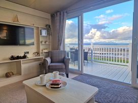 A living room with a sofa and a view of the outdoors at Craig Tara Holiday Park - Holiday Accommodation 12278 Ayr