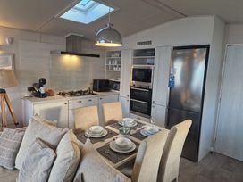 A kitchen with a dining table and appliances at Craig Tara Holiday Park - Holiday Accommodation 12278 Ayr