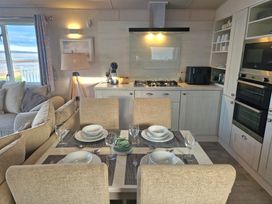 A kitchen with dining area and appliances at Craig Tara Holiday Park - Holiday Accommodation 12278 Ayr