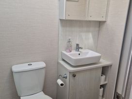 A bathroom with a sink and toilet at Craig Tara Holiday Park - Holiday Accommodation 12278 Ayr
