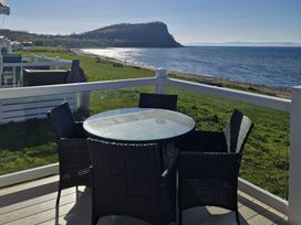 An outdoor seating area with a table and chairs at Craig Tara Holiday Park - Holiday Accommodation 12278, Ayr