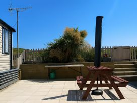 An outdoor area with seating and a table at Freshwater Beach Holiday Park - Holiday Accommodation 12281 in Burton Bradstock