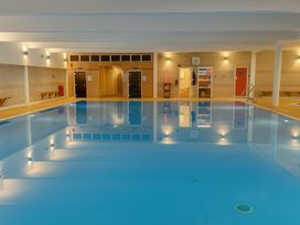 An indoor pool area with seating and facilities at Freshwater Beach Holiday Park - Holiday Accommodation 12281, Burton Bradstock