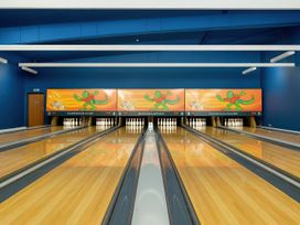 A bowling alley with lanes and colorful walls at Freshwater Beach Holiday Park - Holiday Accommodation 12281, Burton Bradstock