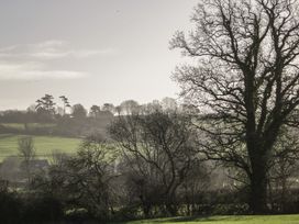 A landscape with trees and hills at Maud Heath's Snug in East Thytherton