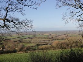 A view of fields and trees at Maud Heath's Snug in East Thytherton