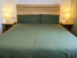 A bedroom with a bed and bedside tables at Littlesea Holiday Park - Holiday Accommodation 13127, Weymouth
