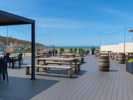 An outdoor area with tables and chairs at Littlesea Holiday Park - Holiday Accommodation 13127 in Weymouth