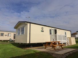A holiday home with a picnic table outside at Littlesea Holiday Park - Holiday Accommodation 13127 in Weymouth