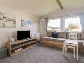 A living room with a TV and sofa at Littlesea Holiday Park - Holiday Accommodation 13127 in Weymouth