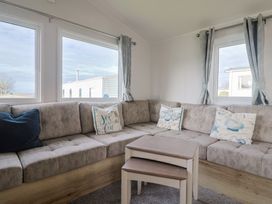 A living room with a sofa and table at Littlesea Holiday Park - Holiday Accommodation 13127 Weymouth