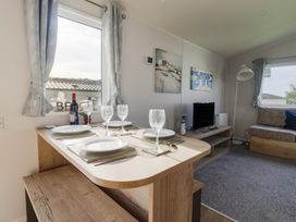 A dining area with a table set for four at Littlesea Holiday Park - Holiday Accommodation 13127, Weymouth