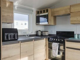 A kitchen with microwave, toaster, kettle, sink and oven at Littlesea Holiday Park - Holiday Accommodation 13127, Weymouth