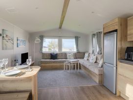 A living room with a sofa and tables at Littlesea Holiday Park - Holiday Accommodation 13127 Weymouth