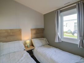 A bedroom with two single beds and a window at Littlesea Holiday Park - Holiday Accommodation 13127, Weymouth