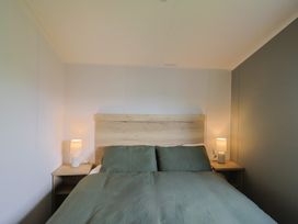 A bedroom with a double bed and bedside tables at Littlesea Holiday Park - Holiday Accommodation 13127 in Weymouth