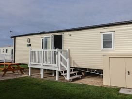 A mobile home with steps and a picnic table at Littlesea Holiday Park - Holiday Accommodation 13127 in Weymouth