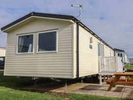 A mobile home with a patio area at Littlesea Holiday Park - Holiday Accommodation 13127 Weymouth