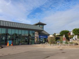 An outdoor area with a building and landscaping at Littlesea Holiday Park - Holiday Accommodation 13127 Weymouth