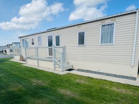 An exterior view of a caravan with a deck at Golden Palm Resort - Holiday Accommodation 13363 Skegness