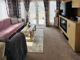 A living room with a sofa, coffee table, and TV at Golden Palm Resort - Holiday Accommodation 13363 in Skegness