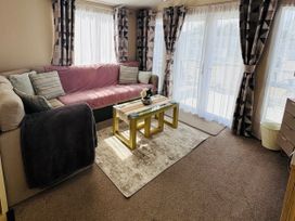 A living room with a sofa and coffee table at Golden Palm Resort - Holiday Accommodation 13363 Skegness