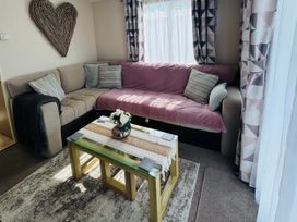 A living room with a sofa and coffee table at Golden Palm Resort - Holiday Accommodation 13363 in Skegness