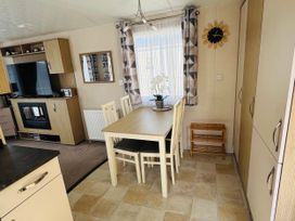 A dining room featuring a table and chairs at Golden Palm Resort - Holiday Accommodation 13363 Skegness