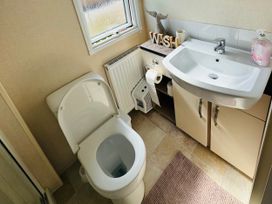 A bathroom with a toilet and hand basin at Golden Palm Resort - Holiday Accommodation 13363 Skegness