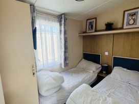 A bedroom with two beds and a window at Golden Palm Resort - Holiday Accommodation 13363 Skegness