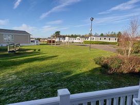 An outdoor area with holiday homes and a playground at Devon Cliffs Holiday Park - Holiday Accommodation 13607 in Exmouth