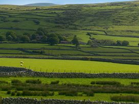 a rural landscape with stone walls and fields at Lyons Sunnysands Holiday Park - Holiday Accommodation 13733 in Barmouth