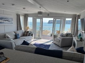 A living room with a view of the sea at Lydstep Beach - Holiday Accommodation 14896 in Tenby