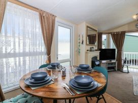 A dining room with a table set for four at Sunnysands in Talybont near Barmouth