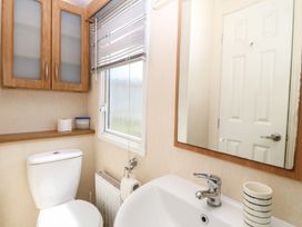 A bathroom with a sink and toilet at Sunnysands Talybont near Barmouth
