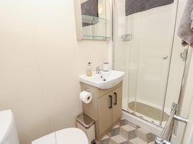 A bathroom with a sink and shower at Pine Tree Lodge - Shorefield Country Park Milford On Sea