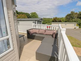 A seating area with a sofa and table at Pine Tree Lodge - Shorefield Country Park Milford On Sea