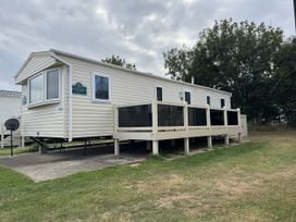 A mobile home with a deck at Thornwick Bay Holiday Village - Holiday Accommodation 15653 Bridlington