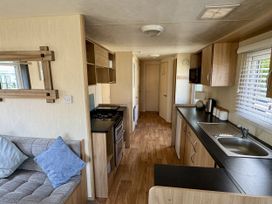 A kitchen with a couch and an oven at Thornwick Bay Holiday Village - Holiday Accommodation 15653 in Bridlington