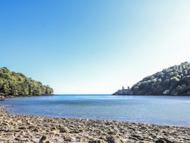 A view of a rocky shore and trees with water at Fastnet at Nonsuch House in Dartmouth