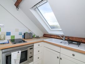 A kitchen with a sink and stove Fastnet at Nonsuch House Kingswear, Devon
