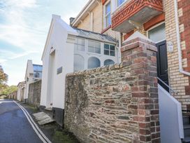 A house with a wall and windows at Fastnet at Nonsuch House Kingswear, Devon