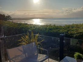 A view of the sea and sun from a terrace at Hafan y Mor Haven - Holiday Accommodation 16251, Pwllheli