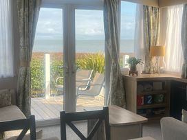 A living room with a view of the sea at Hafan y Mor Haven - Holiday Accommodation 16251 Pwllheli