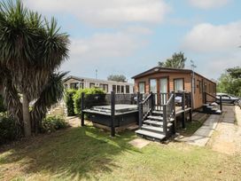 An outdoor area with a caravan and hot tub at Tattershall Lakes Country Park - Holiday Accommodation 16408 Tattershall