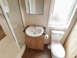 A bathroom featuring a sink, toilet, and shower at Tattershall Lakes Country Park - Holiday Accommodation 16408, Tattershall