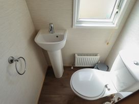 A bathroom with a sink and toilet at Tattershall Lakes Country Park - Holiday Accommodation 16408 in Tattershall
